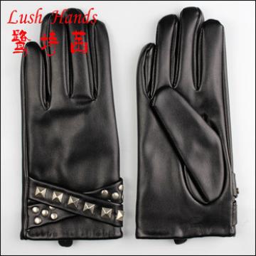 lady&#39;s fingered black genuine gloves decorated with round and point rivets on belts