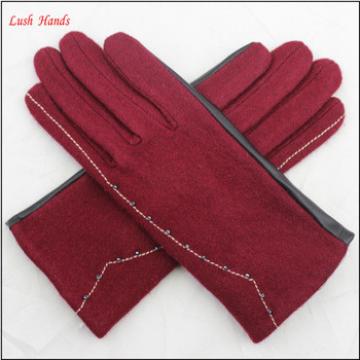 ladies back woolen and palm pu leather together style gloves have small fake fur ball