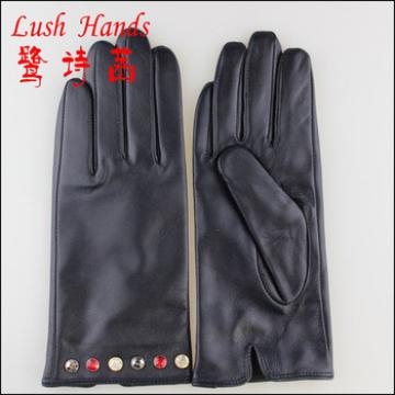Black leather gloves with coloful jewels to adapt fashion trend