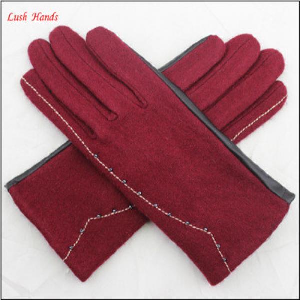 ladies back woolen and palm pu leather together style gloves have small fake fur ball #1 image