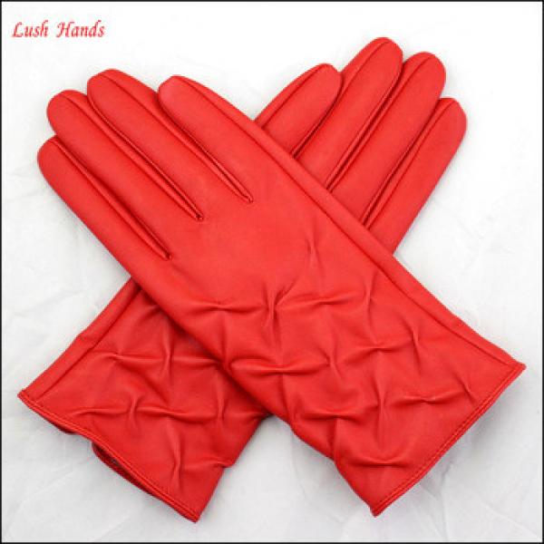 red leather hand gloves winter gloves girls putting on fashion gloves #1 image